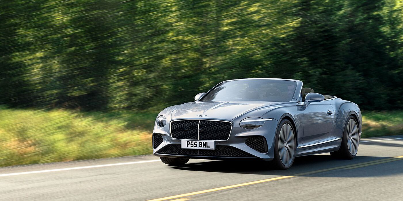 Bentley Edinburgh New Bentley Continental GTC convertible front view in Silverlake paint with 22 inch ten spoke wheels, driving dynamically on a country road