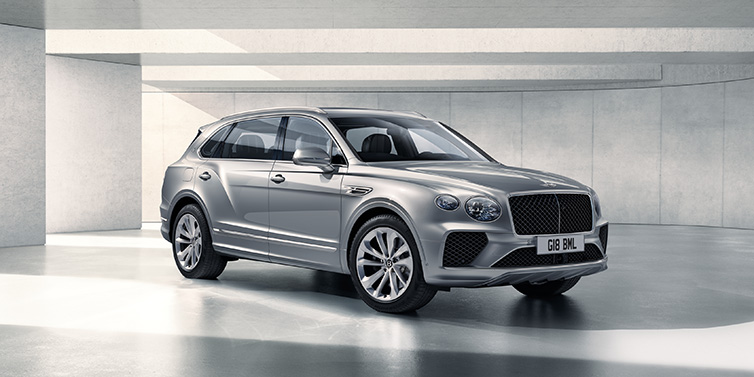 Bentley Edinburgh Bentley Bentayga Extended Wheelbase SUV front three quarter in Moonbeam paint with a grey background