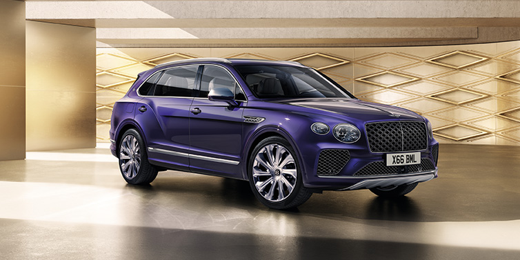 Bentley Edinburgh Bentley Bentayga Extended Wheelbase Mulliner SUV front three quarter in Tanzanite Purple paint with a gold patterned background