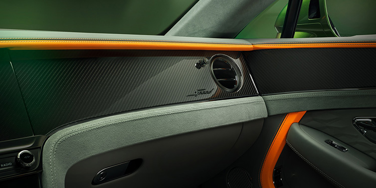 Bentley Edinburgh Bentley Continental GT Speed coupe front interior dash detail with high gloss carbon fibre veneer surrounded by Mandarin by Mulliner and Gravity Grey hides