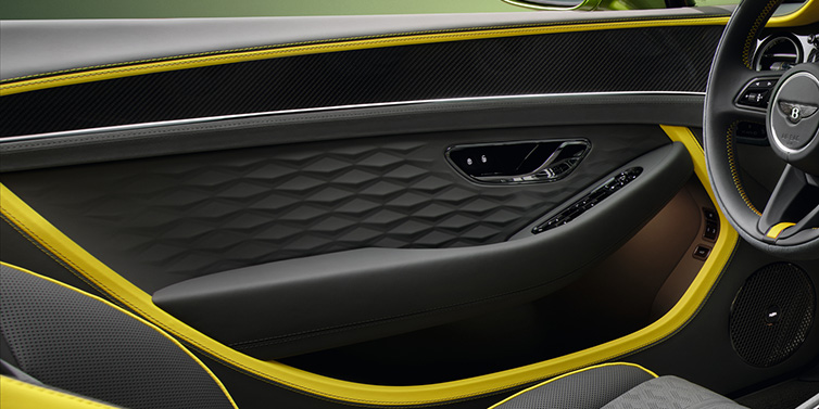 Bentley Edinburgh Bentley Continental GTC Speed convertible interior door details featuring Gravity Grey and Cyber Yellow by Mulliner hides and high gloss carbon fibre veneer