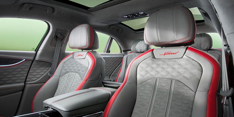 Bentley Edinburgh Bentley Flying Spur Speed sedan interior showing front and rear seats in Hotspur red and Gravity Grey hides, with Speed seat emblems