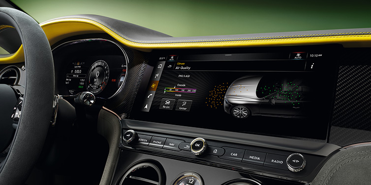 Bentley Edinburgh Bentley Continental GTC Speed convertible front interior centre console with MMI screen showing Air Quality visualisation surrounded by Cyber Yellow by Mulliner and Gravity Grey hides and high gloss carbon fibre veneer