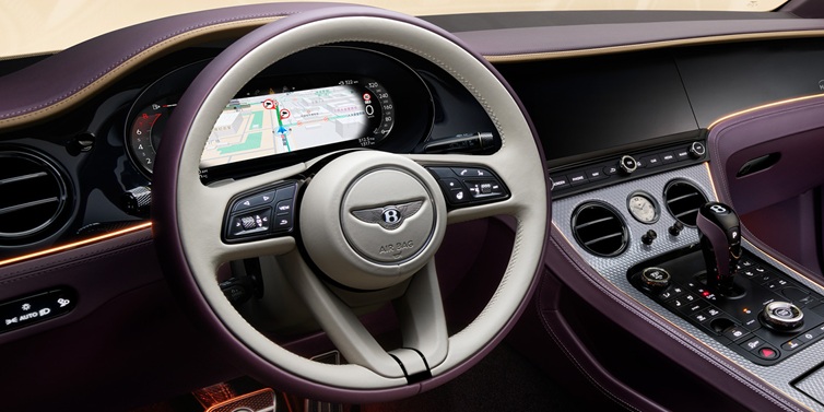 Bentley Edinburgh Bentley Continental GT Mulliner coupe front interior showing steering wheel and drivers screens surrounded by Linen and Damson hides and Grand Black veneer